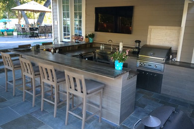Patio kitchen - large traditional backyard tile patio kitchen idea in Other with a roof extension