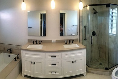 Corner shower - modern beige floor corner shower idea in Los Angeles with shaker cabinets, white cabinets, an undermount tub, beige walls, an undermount sink and a hinged shower door