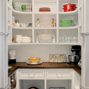 Traditional kitchen pantry inspiration - Inspiration for a timeless u-shaped kitchen pantry remodel in Chicago with open cabinets, white cabinets and wood countertops