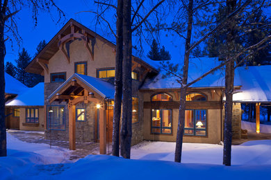 Inspiration for a mid-sized rustic multicolored two-story stone exterior home remodel in Other with a metal roof