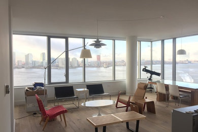 Example of a mid-sized minimalist open concept medium tone wood floor and brown floor living room design in New York with white walls