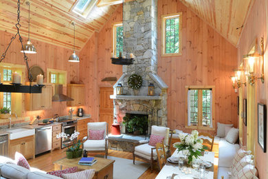 Country open concept living room in Boston with a standard fireplace and a stone fireplace surround.