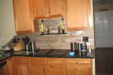 Mid-sized elegant u-shaped open concept kitchen photo in Philadelphia with shaker cabinets, light wood cabinets, quartz countertops, multicolored backsplash, stone tile backsplash and stainless steel appliances