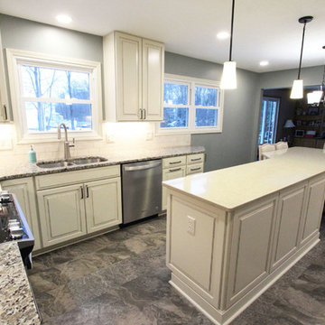 Beige Kitchen with Extra Large Island, Tile Backsplash and Granite Countertops