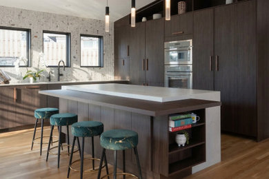 Inspiration for a mid-sized scandinavian l-shaped light wood floor, beige floor and vaulted ceiling eat-in kitchen remodel in DC Metro with an undermount sink, flat-panel cabinets, dark wood cabinets, quartz countertops, multicolored backsplash, stone slab backsplash, stainless steel appliances, an island and white countertops