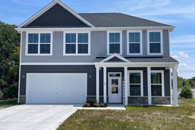 Inspiration for a mid-sized timeless gray two-story mixed siding and board and batten house exterior remodel in DC Metro