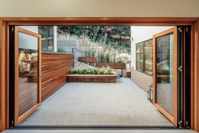 Inspiration for a small modern backyard patio in San Francisco with a container garden, natural stone pavers and no cover.