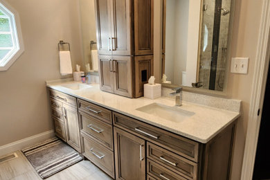 Example of a large minimalist 3/4 ceramic tile, gray floor and double-sink bathroom design in Other with shaker cabinets, beige walls, an undermount sink, quartz countertops, beige countertops and a built-in vanity