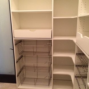 Photo of a mid-sized modern l-shaped kitchen pantry in Detroit with flat-panel cabinets and white cabinets.