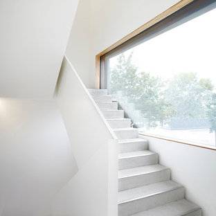 Inspiration for a large contemporary concrete u-shaped staircase in Munich with concrete risers.