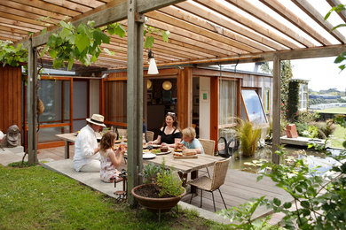 Inspiration for a contemporary backyard deck in Other with a pergola.