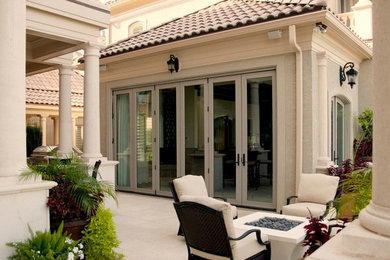 Inspiration for a large timeless backyard decomposed granite patio remodel in Charlotte with a fire pit and a roof extension