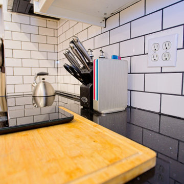 Black Quartz Kitchen Counter with Subway Tile and Wood Accessories | East York