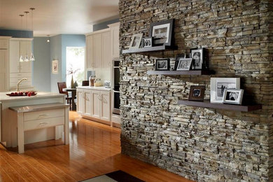 Eat-in kitchen - mid-sized traditional l-shaped medium tone wood floor eat-in kitchen idea in Chicago with an undermount sink, shaker cabinets, white cabinets, solid surface countertops, stainless steel appliances and an island