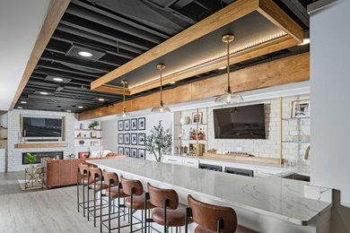 Inspiration for a mid-sized contemporary u-shaped light wood floor and gray floor seated home bar remodel in Detroit with a drop-in sink, open cabinets, white cabinets, marble countertops, white backsplash, brick backsplash and white countertops