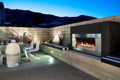 Mid-sized trendy backyard stamped concrete patio photo in Vancouver with a fire pit and no cover