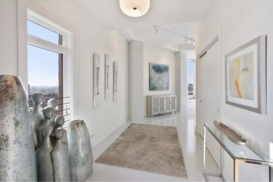 Mid-sized trendy white floor hallway photo in Atlanta with white walls