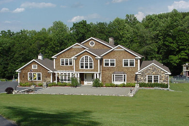 Example of a large classic two-story wood exterior home design in New York with a shingle roof