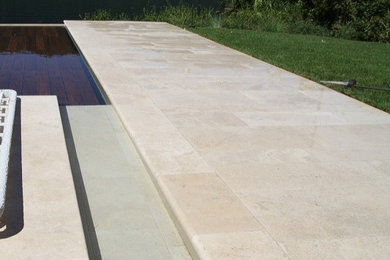 Immagine di una piscina contemporanea con pavimentazioni in pietra naturale