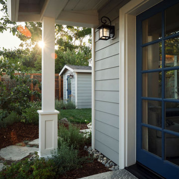 Cape Cod ADU Entry with Matching Garden Shed and Landscaped Yard