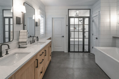 Bathroom - large modern master white tile and ceramic tile ceramic tile, gray floor, double-sink and shiplap wall bathroom idea in Milwaukee with recessed-panel cabinets, light wood cabinets, white walls, an undermount sink, quartzite countertops, a hinged shower door, white countertops and a freestanding vanity