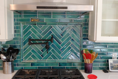 Inspiration for a mid-sized transitional u-shaped ceramic tile, white floor and vaulted ceiling eat-in kitchen remodel in Boise with a farmhouse sink, shaker cabinets, white cabinets, quartzite countertops, green backsplash, ceramic backsplash, stainless steel appliances, an island and white countertops