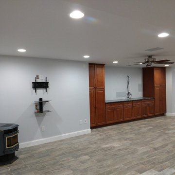 Basement remodel with hidden audio theater area and wet bar