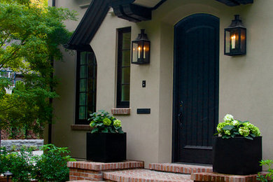 Example of a large classic beige two-story stucco gable roof design in Portland