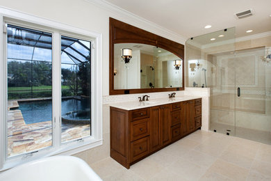 Large elegant master beige tile and ceramic tile ceramic tile bathroom photo in Tampa with furniture-like cabinets, medium tone wood cabinets, a one-piece toilet, beige walls, quartz countertops and an undermount sink