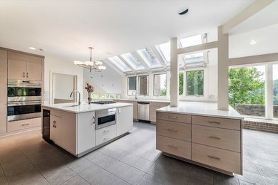 Large minimalist u-shaped porcelain tile and gray floor eat-in kitchen photo in Philadelphia with an undermount sink, flat-panel cabinets, light wood cabinets, quartz countertops, multicolored backsplash, marble backsplash, stainless steel appliances and an island