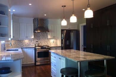 Mid-sized elegant u-shaped medium tone wood floor kitchen photo in Ottawa with an undermount sink, recessed-panel cabinets, quartz countertops, ceramic backsplash, stainless steel appliances and an island