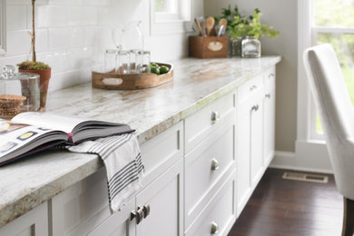 Eat-in kitchen - mid-sized transitional single-wall dark wood floor eat-in kitchen idea in Atlanta with quartz countertops, shaker cabinets, white cabinets, white backsplash, subway tile backsplash and no island