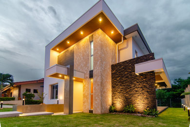 Example of a trendy white two-story house exterior design in Other