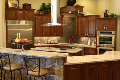 Open concept kitchen - large l-shaped dark wood floor open concept kitchen idea in Houston with an undermount sink, dark wood cabinets, stainless steel appliances and an island