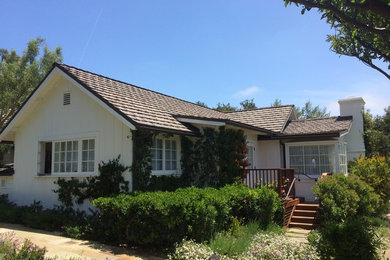 Mid-sized traditional beige one-story wood gable roof idea in New Orleans
