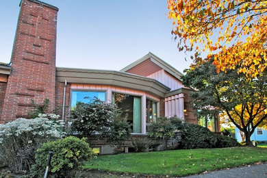 Minimalist red one-story brick exterior home photo in Portland
