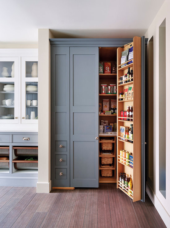 Traditional kitchen pantry designs - Example of a classic medium tone wood floor kitchen pantry design in London with shaker cabinets and gray cabinets