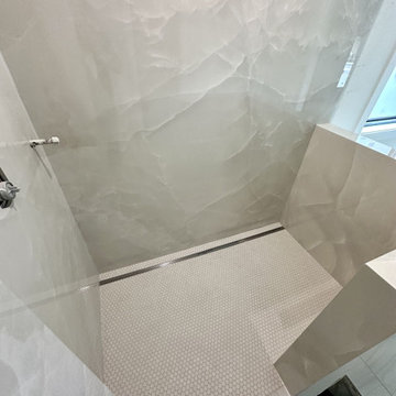 Large-format porcelain panel shower with linear drain