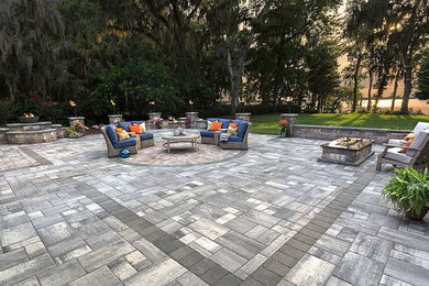 Large transitional backyard stamped concrete patio photo in Tampa with a fire pit and no cover