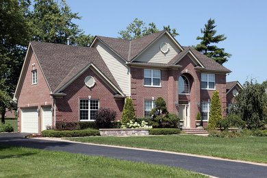 Large traditional red two-story brick exterior home idea in Richmond with a shingle roof
