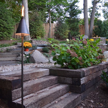 Alexandria Sloped Yard - Raised Patio, Fire Pit, & Water Feature
