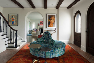 Example of a mid-sized tuscan marble floor entryway design in Minneapolis with white walls and a dark wood front door