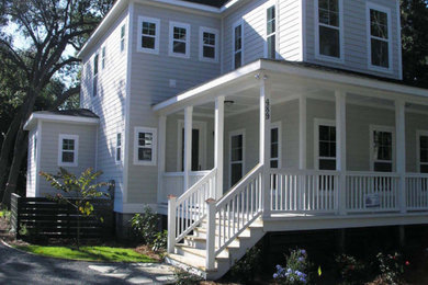 Large elegant gray two-story wood house exterior photo in Orlando with a hip roof and a shingle roof