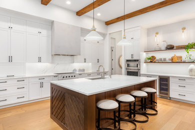 Example of a large transitional l-shaped yellow floor and exposed beam eat-in kitchen design in San Francisco with a single-bowl sink, white cabinets, stone slab backsplash, stainless steel appliances, an island and white countertops