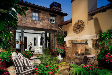 Mediterranean patio in Sacramento with a fire feature and no cover.