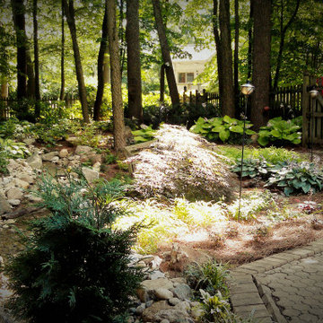 Shady Backyard with Waterfall, Stream, Fireplace and Landscape