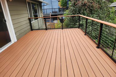 Example of a mid-sized backyard second story metal railing deck design in Portland