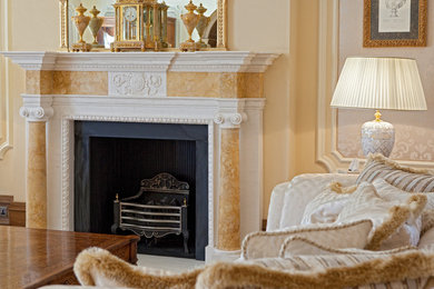 This is an example of a large classic formal living room in London with beige walls, carpet, a standard fireplace, a stone fireplace surround and yellow floors.