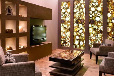 Large trendy medium tone wood floor living room photo in Atlanta with beige walls and a wall-mounted tv