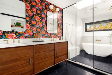 Example of a large 1960s gray tile black floor and double-sink bathroom design in Seattle with flat-panel cabinets, medium tone wood cabinets, multicolored walls, an undermount sink, white countertops and a freestanding vanity